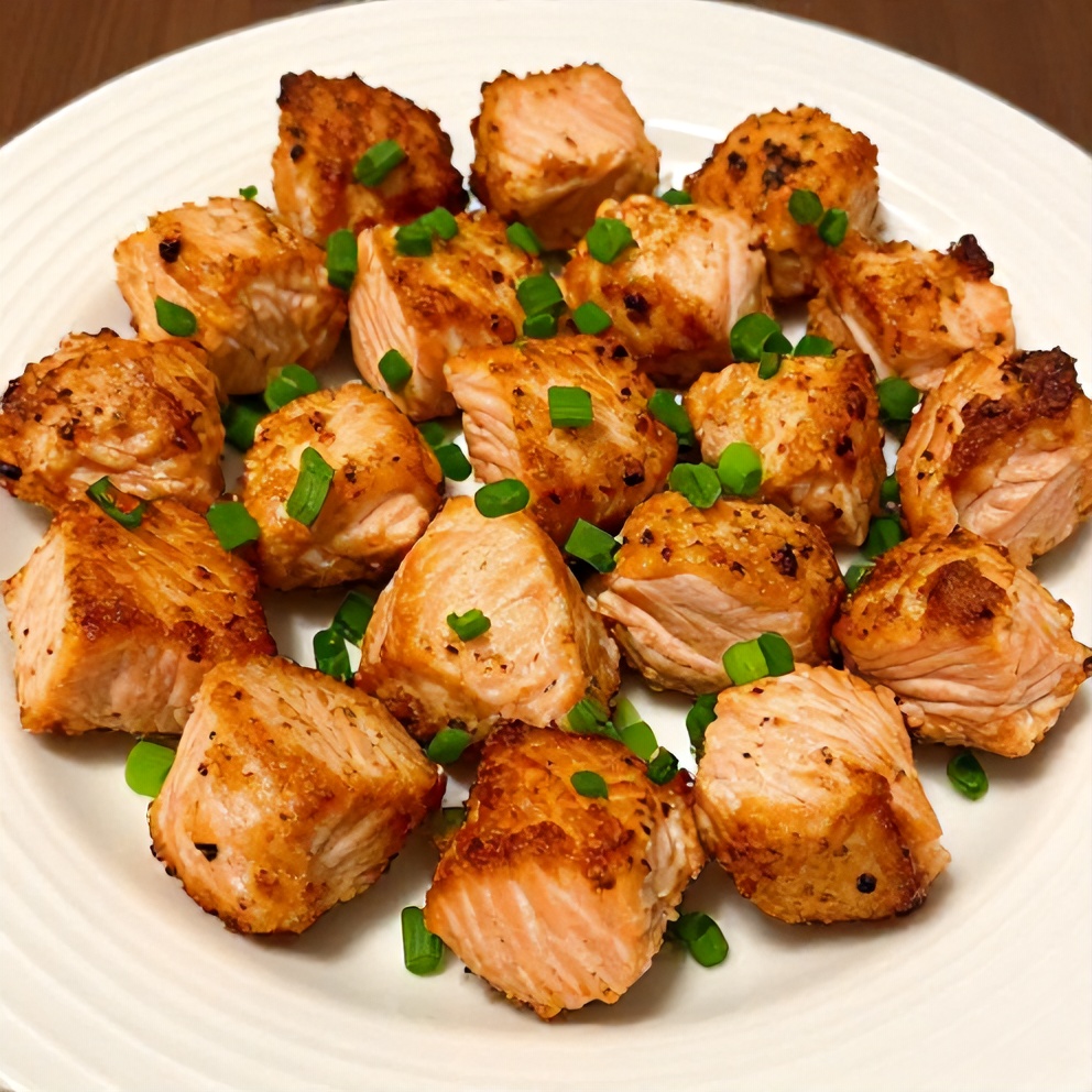 Plated Bang Bang Salmon Bites with green onions