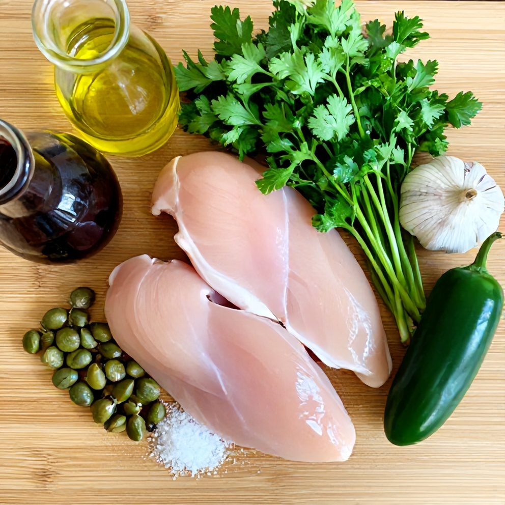 Ingredients for Easy Salsa Verde Chicken laid out on a wooden cutting board