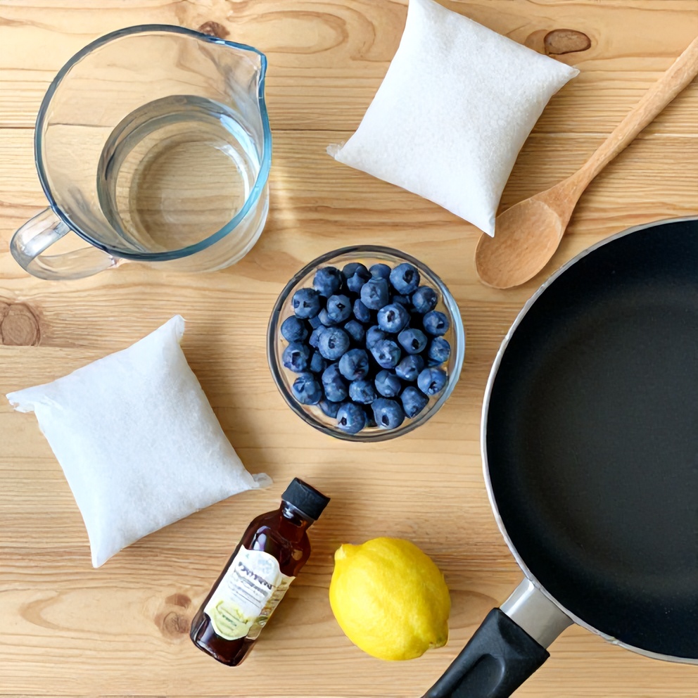 Ingredients for sugar free blueberry syrup laid out on a wooden surface
