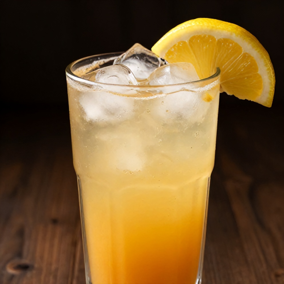 A glass of Peach Ginger Lemonade with ice cubes and a lemon wheel garnish