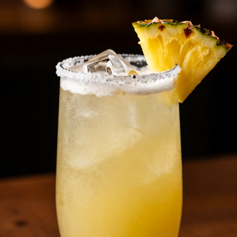 Pineapple Margarita Mocktail served in a glass with salted rim and pineapple wedge garnish