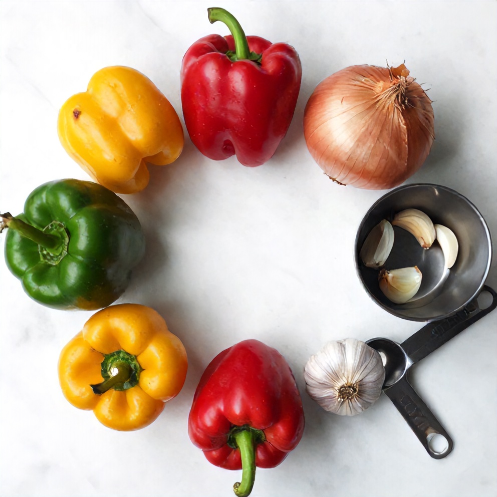 Raw ingredients for crispy fajita veggies on a wooden surface