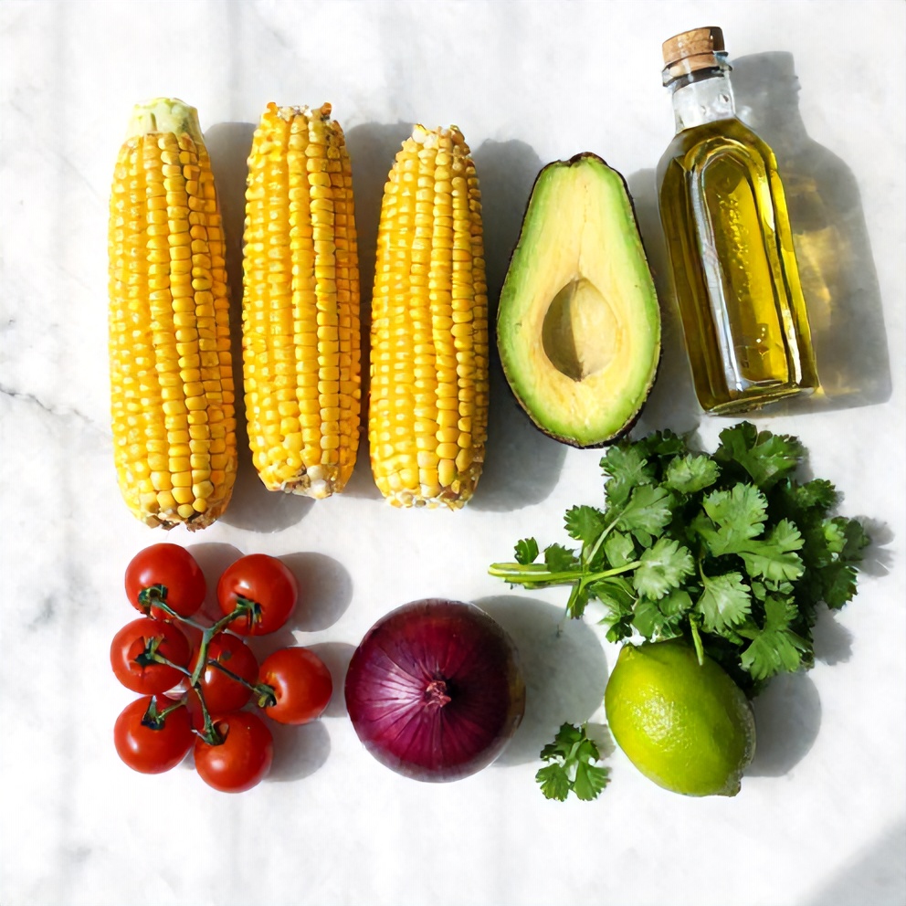 Raw ingredients for summer corn salad: corn on the cob, avocado, cherry tomatoes, red onion, cilantro, lime, and olive oil